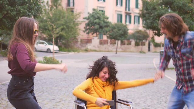young disabled person enjoying listening to music and dancing with her friends