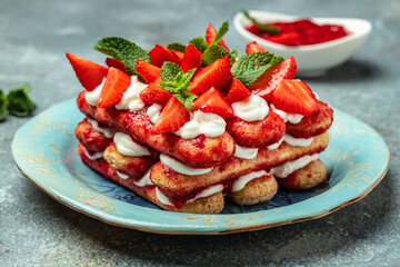 Traditional italian dessert with strawberry and mascarpone on light background. Long banner format