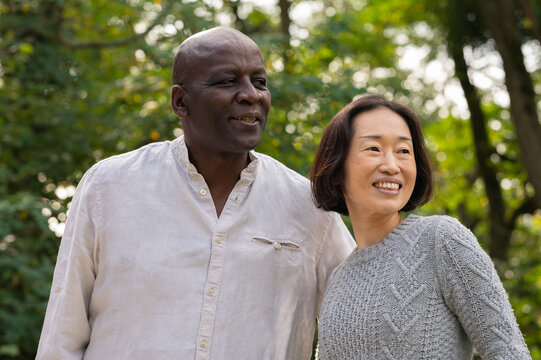 Middle-aged Diverse Couple Hanging Out Inpublic Park