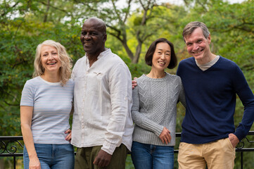 Naklejka premium Middle-aged diverse couples hanging out in public park
