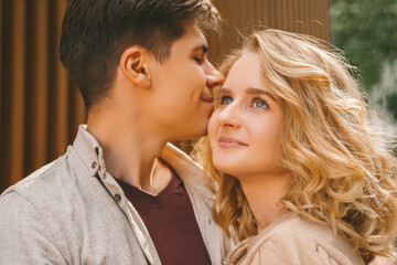Fototapeta premium Close up portrait of an in love couple enjoying each others presence outdoors in the street.