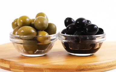 Black and green olives in glass containers. Christmas table. Shallow depth of field