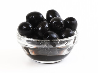 Black olives in a glass container. Shallow depth of field