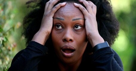 African woman reacting with SHOCK and SURPRISE