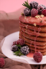 sweet fragrant lush pink heart-shaped pancakes with pink delicious icing on top and decorated with raspberries and blackberries with green rosemary sprigs. for signage, menu labels, and more