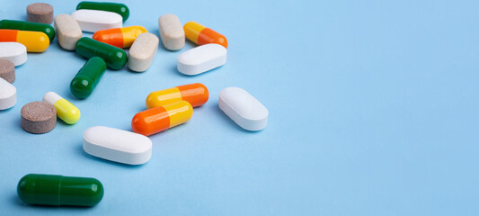 Top view of different pills on blue background,large banner with