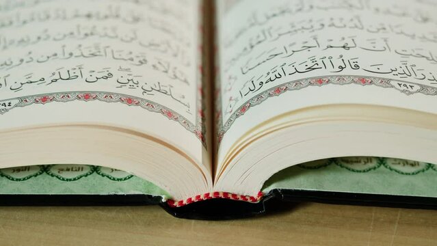 The Holy Quran Book, koran Chapter, flipping pages Close up Macro.