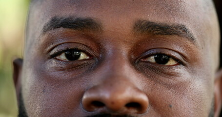 African man eyes close-up face looking at camera, macro closeup