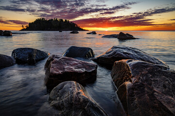 Sunset over Lake Superior. The sun sets over the lake at Presque Isle Park near Marquette Michgian