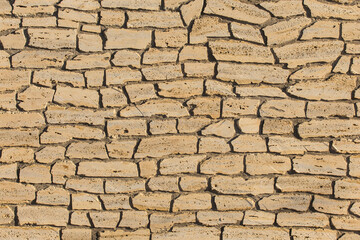Sand color stone or brick wall, modern texture background