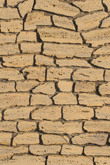 Sand color stone brick beige vertical wall, modern texture ancient pattern background abstract