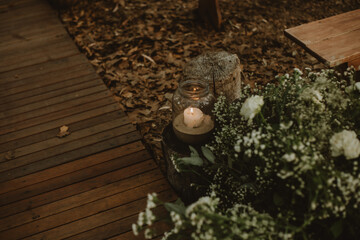 Decorated luxury wedding ceremony place in the garden. White empty chairs and arch decorated with plants.