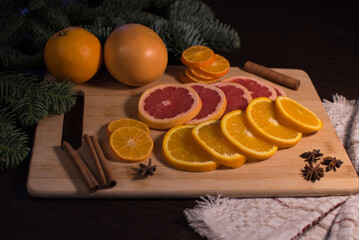 tangerines and oranges are sliced ​​on a board. christmas tangerines and oranges. sweet christmas treat