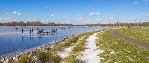 Panorama of lakeside of the the frozen Paterswoldse Meer lake in Groningen, Netherlands - obrazy, fototapety, plakaty