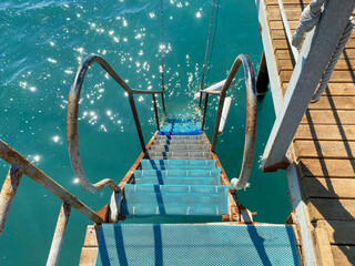 Iron railings and steps for descending into the sea on vacation in a heavenly warm eastern tropical country resort