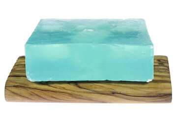 Dead Sea salt soap on olive wood underlay  isolated on white background