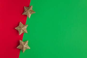 Golden sparkling stars on a red and green background.