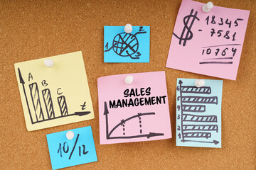 On the board are stickers with graphs and diagrams and the inscription - Sales Management