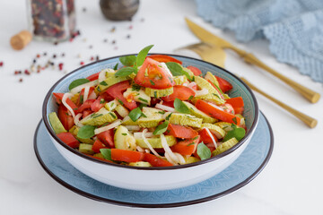 Roasted summer squash Tomato Salad with onion and vinaigrette dressing.
