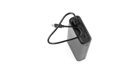 Fototapeta premium Additional self-contained external battery for charging mobile and other device. Power bank isolated on white background. Stylish charger (rechargeable battery). Full depth of field.