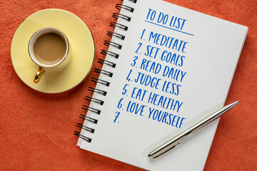 inspirational to do list in a notebook - meditate, set goals, read daily, judge less, eat healthy,...