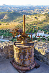 Old press to make olive oil next to fields full of olive trees in the province of Cadiz, Spain.