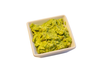 Bowl of guacamole isolated on white background