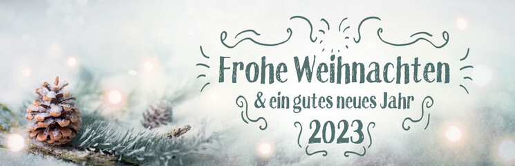 Fototapeta na wymiar Christmas greeting card 2022 2023 - Panorama, Banner, German language - Merry Christmas and Happy New Year - Xmas Congratulations Card - Fir branch in snow landscape with magic lights 