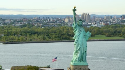 Aerial View Of The Statue Of Liberty Orbiting At Daylight, New York City. New York Aerial Shot. Wide Shot. 
US. Flag.  United States. High Quality Footage Shot from Helicopter.