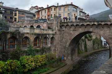 Naklejka na ściany i meble view of a bridge over a river in the village of Potes in Cantabria, Spain