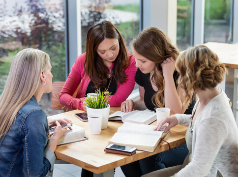A group of women gathered together for a Bible study in a coffee shop at a church; Edmonton, Alberta, Canada