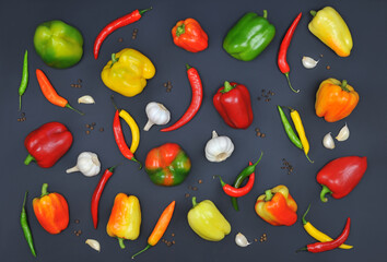 peppers background. Colorful sweet pepper ,chili, garlic and allspice isolated on black background. Top view ,flat lay