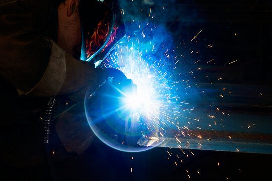 A journeyman welder installing a lift lug using a MIG welder in a metal fabrication plant; Innisfail, Alberta, Canada
