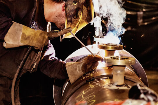 Journeyman Tradesman Welding A Nozzle Into A Three Phase Separator At A Metal Fabrication Plant; Innisfail, Alberta, Canada