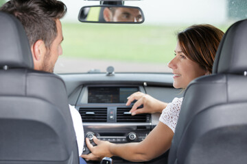 happy couple inside a new car