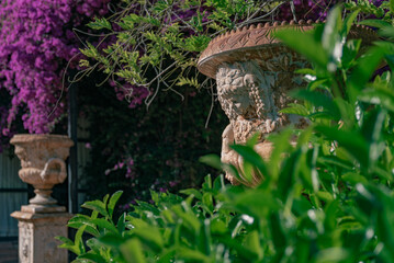Old decorative vase in the garden next to bamboo