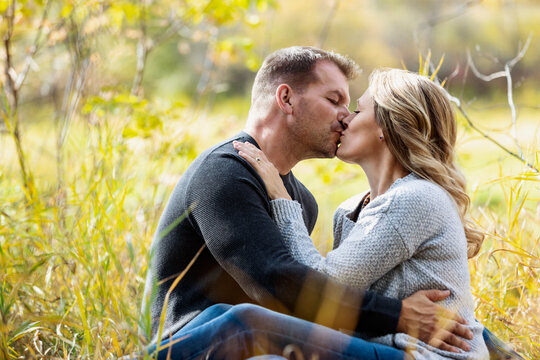 A married couple spending quality time together outdoors in a city park during the fall season; St. Albert, Alberta, Canada