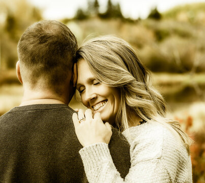 A married couple spending quality time together outdoors in a city park during a warm fall afternoon; St. Albert, Alberta, Canada
