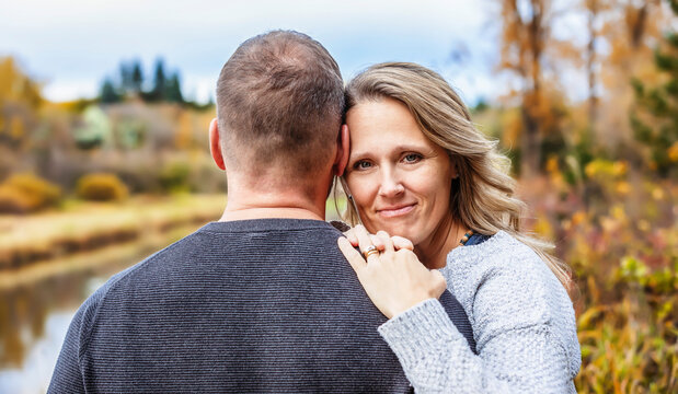 A married couple spending quality time together outdoors in a city park during a warm fall afternoon; St. Albert, Alberta, Canada