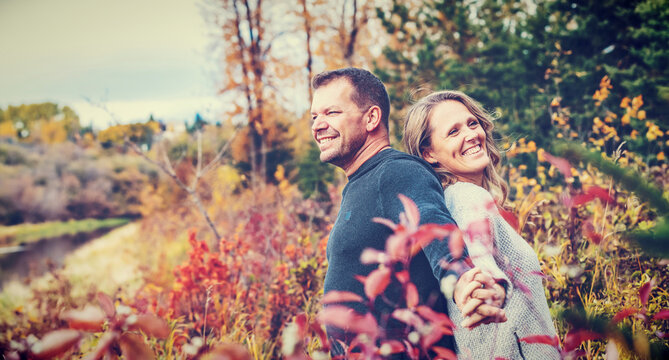 A married couple spending quality time together outdoors in a city park during a warm fall afternoon; St. Albert, Alberta, Canada