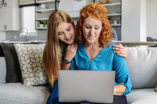 Mother and daughter looking at a laptop computer together; Edmonton, Alberta, Canda