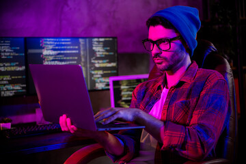 Photo of serious confident freelancer wear hat eyeglasses eb designing modern gadget indoors...