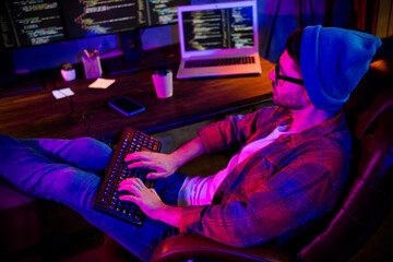 Photo of thoughtful serious freelancer wear hat eyeglasses web designing modern device indoors workplace workstation loft