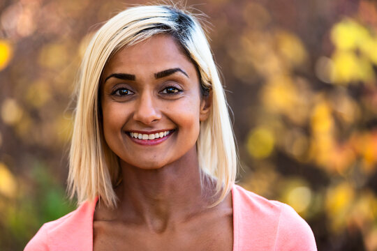 Head and shoulders portrait of a woman outdoors in autumn; Edmonton, Alberta, Canada
