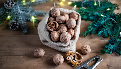 festive christmas nuts tumbling from a burlap bag