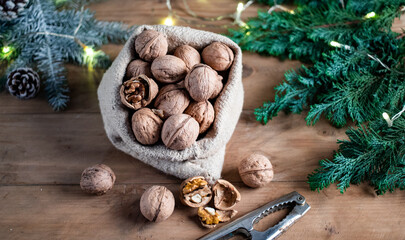 festive christmas nuts tumbling from a burlap bag