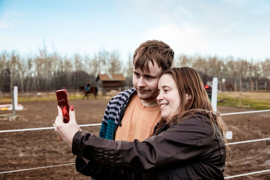A mom with epilepsy taking a self-portrait with her son who has Aspberger Syndrome at an equine centre; Westlock, Alberta, Canada
