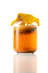Jar of fermenting kombucha isolated on white