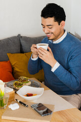 Caucasian man smiling and having breakfast in a restaurant. Lifestyle.