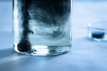 Iron nanoparticles in a lab, on a white glossy surface